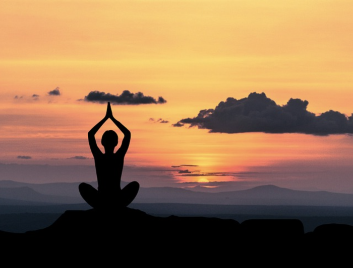 Yoga pose in front of a sunset